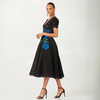 Helsi Amy DR6262 Black Lace Midi Dress with Floral Embroidery - Elegant black lace midi dress with short puffed sleeves, fitted bodice, flared skirt, plunging neckline, and blue floral embroidery.  Side View.