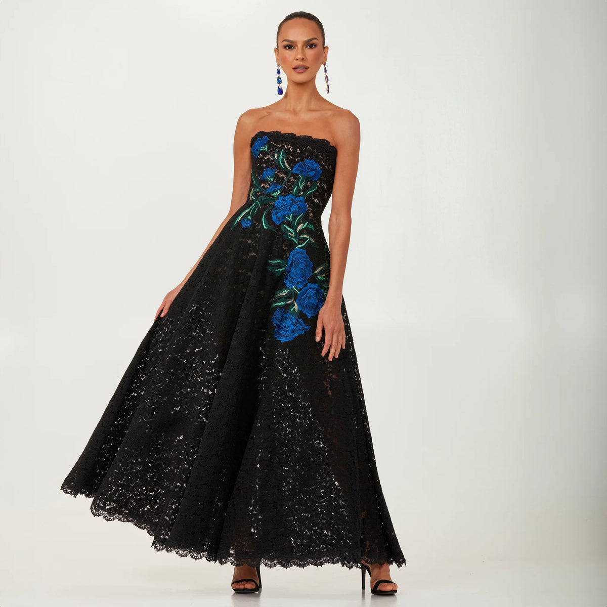 Helsi Patricia DR6252 strapless gown with blue floral embroidery - elegant black lace gown featuring a fit-and-flare silhouette and striking blue floral details.  Front View.