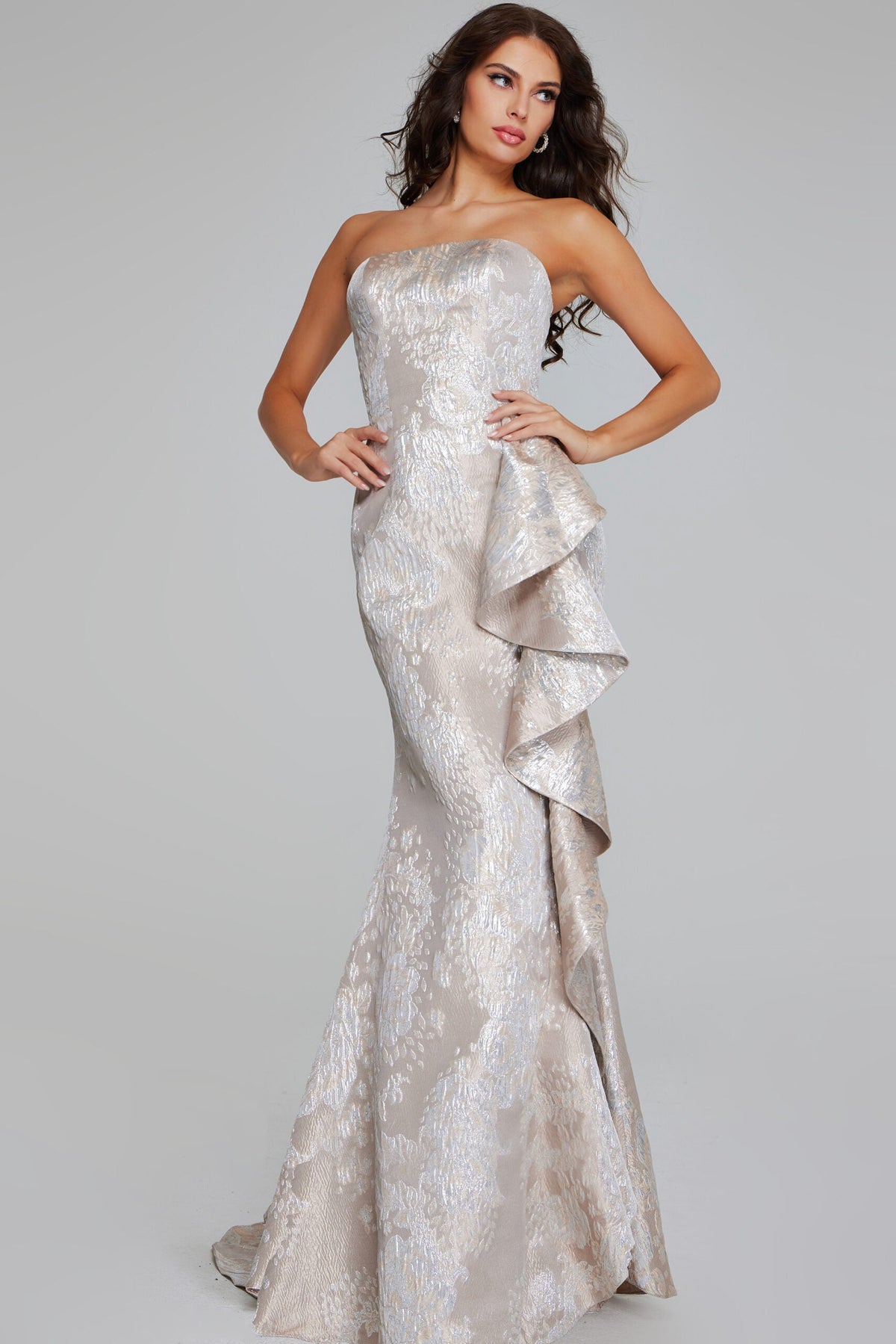 Jovani 42028 Strapless Brocade Gown - Elegant formal gown featuring a strapless silhouette, draped side detail, and luxurious brocade fabric in champagne silver and gunmetal gold.