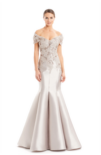 Alexander by Daymor 1667, an off-shoulder evening gown with intricate embroidery, showcasing a form-fitting silhouette and mermaid skirt, perfect for formal events and weddings.  Model is wearing Silver Taupe.