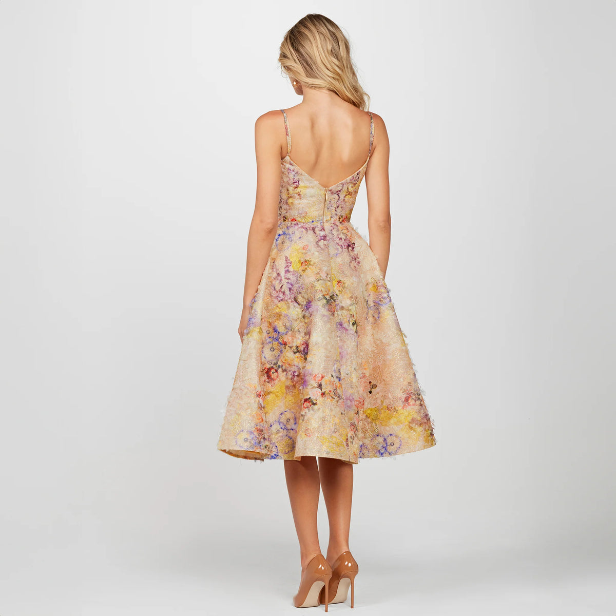 Discover the Helsi Stephanie Fit and Flare Midi Dress. Featuring a demi neckline, scoop back, embroidered lace bodice, and a crepe skirt with asymmetrical floral patterns, this fully lined dress is perfect for formal evenings.