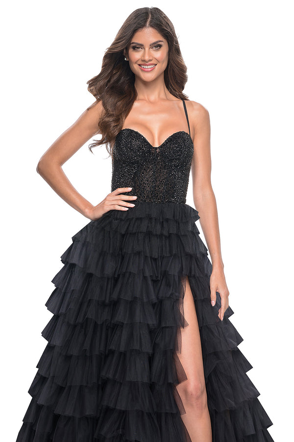 La Femme 32002 Glamorous Rhinestone Embellished Prom Dress - A stunning prom dress featuring a tiered ruffle skirt, fully rhinestone embellished bodice, high slit, and adjustable lace-up back for an elegant and customized look.