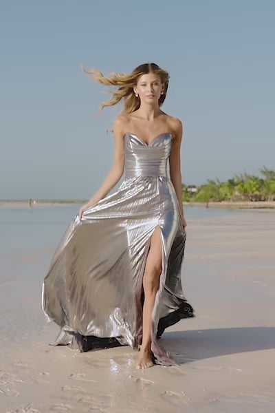 Sherri Hill 56065 Pleated Metallic Strapless Gown with ruched bodice and skirt slit.  This is a video of the model wearing the dress in the color silver.