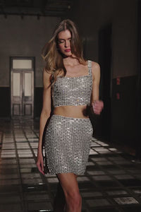 Sherri Hill 56677, a sparkling two-piece cocktail dress with a geometric sequin design, showcasing a cropped top and a matching skirt, perfect for party wear.  This is a video.