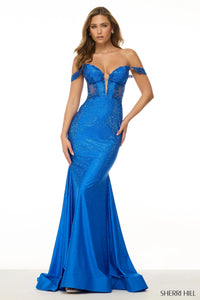 Sherri Hill 61883 Off-the-Shoulder Hot Fix Gown – Blue gown featuring off-the-shoulder design, sheer bodice, lace appliques, and sparkling details.