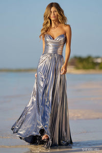 Sherri Hill 56065 Pleated Metallic Strapless Gown with ruched bodice and skirt slit.  The model is wearing the dress in the color silver.