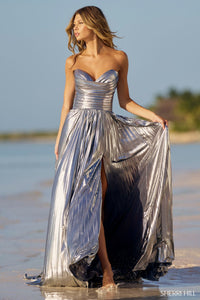 Sherri Hill 56065 Pleated Metallic Strapless Gown with ruched bodice and skirt slit. The model is wearing the dress in the color silver.