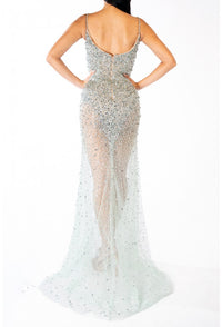 Terani 241P2071 Sparkling Plunge Neckline Evening Gown - A daring and sophisticated gown with a plunging neckline, bodycon silhouette, and sparkling embellishments. Ideal for prom and evening formal events. The model is wearing the dress in the color gunmetal.