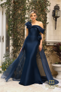 Terani Couture 242M3342 Asymmetric Off-Shoulder Gown with rose detailing, available in navy and emerald. Perfect for formal evening events and Mother of the Bride or Groom.