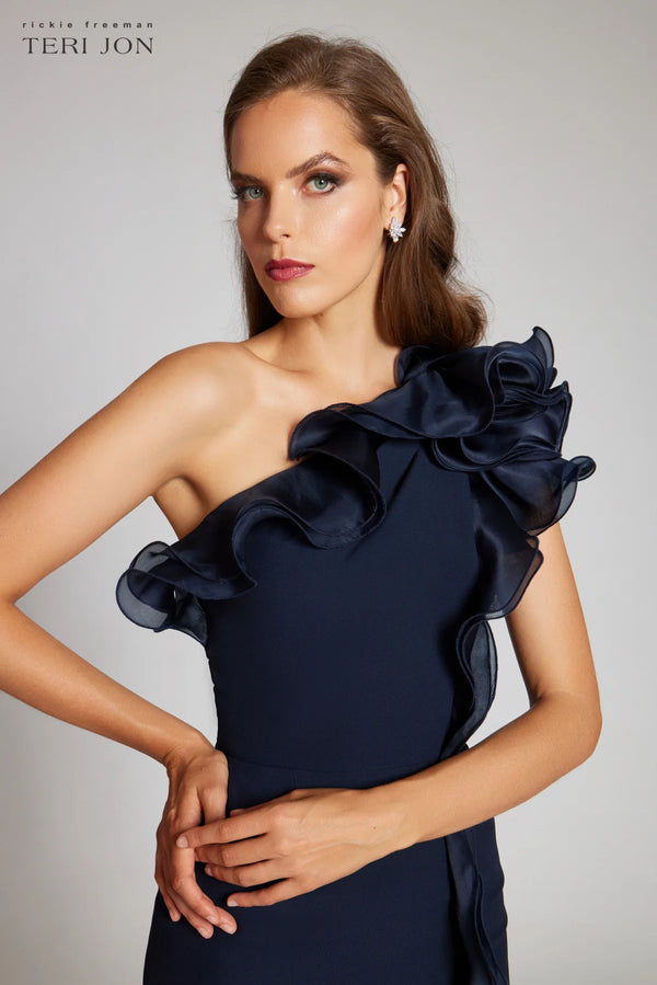 Teri Jon 249043 one-shoulder gown featuring a cascading ruffle detail and fitted silhouette. Perfect for formal evenings and mother of the bride or groom.  Model is wearing the dress in the color navy.