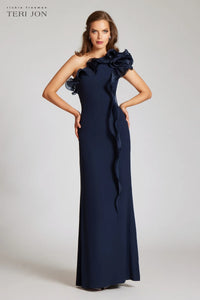 Teri Jon 249043 one-shoulder gown featuring a cascading ruffle detail and fitted silhouette. Perfect for formal evenings and mother of the bride or groom.  Model is wearing the dress in the color navy.